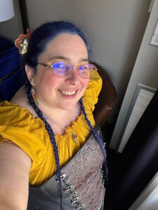 Photo of Rachel Poleke, A white female with dark hair and glasses.